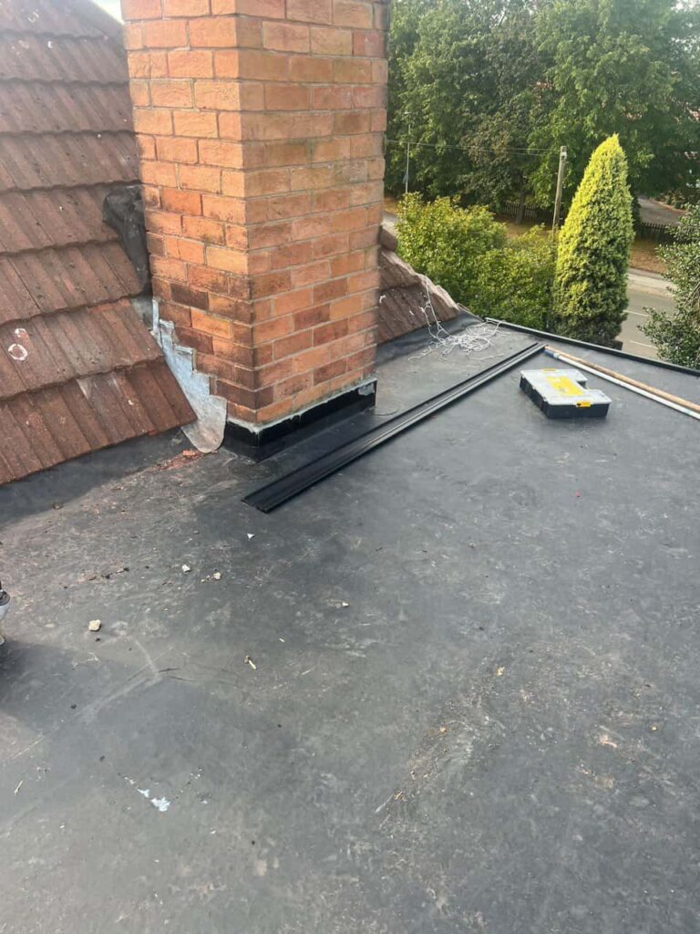 This is a photo of a flat roof which has just been repaired, there is also a chimney stack and some leadwork has also been dressed. Works carried out by LJ Roofing Witney